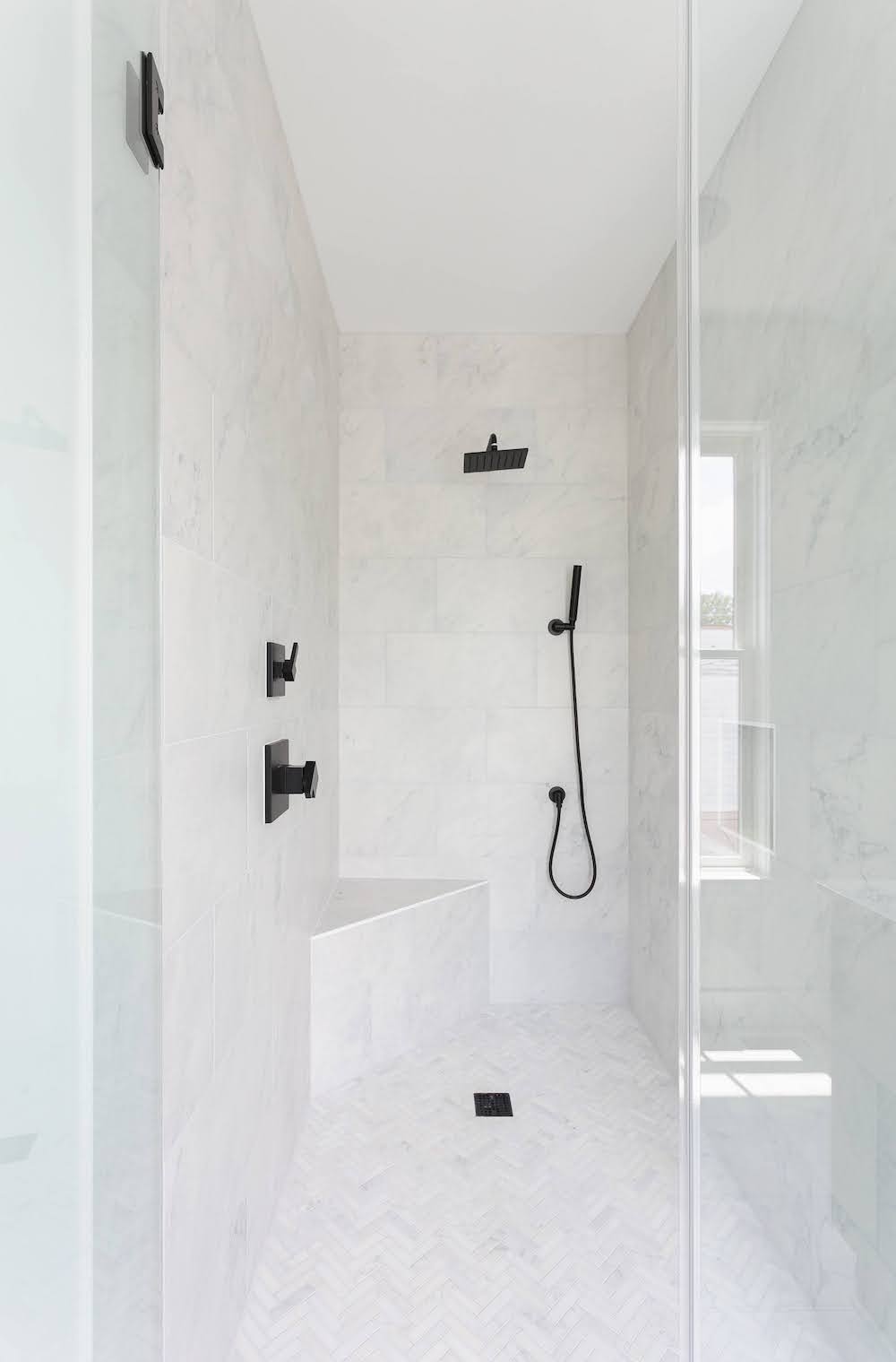Black and white shower, black shower accessories, white tile shower, custom home builder, Charleston, walk-in shower, chevron shower tile, modern custom home