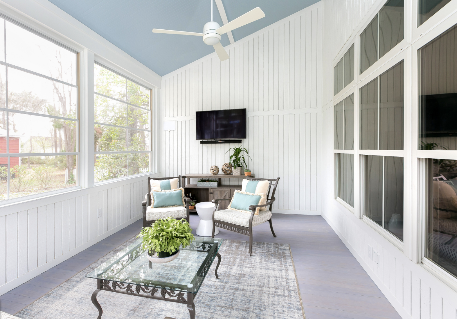 Blue porch ceiling, sun room, outdoor seating, large windows, white panel walls, renovation, custom builder, Daniel Island, custom home